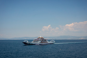 Fototapeta na wymiar Ferry on the sea transports cars and travelers