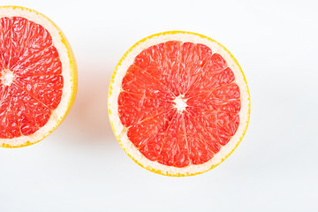 Fototapeta na wymiar Fresh grapefruit red flesh slices on white background