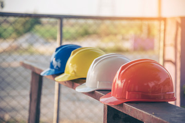 Construction hard hat safety tools equipment for workers in construction site for engineering protection head standard. Many hard hat helmet on row with copy space. Engineering Construction Concept - obrazy, fototapety, plakaty