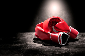 Pair of red boxing gloves under the light