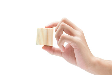 Hand holding wooden block toy