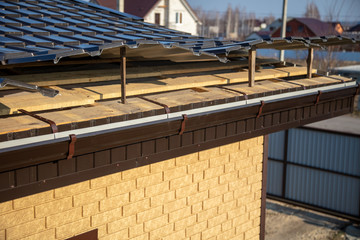 Installation of metal drain on the roof of the house