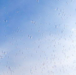 Soap bubbles fly in the blue sky