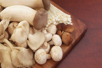 Variety of mushrooms on wooden   board