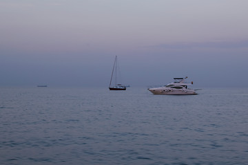 Fototapeta premium Boat in the blue sea, yacht in evening sea after sunset