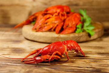 Boiled crayfish on cutting board on wooden table