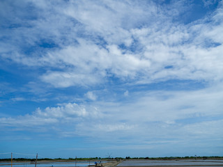 Obraz na płótnie Canvas Sea salt fields local farm industry on a beautiful blue sky in Thailand, salt-pond, salt-farm
