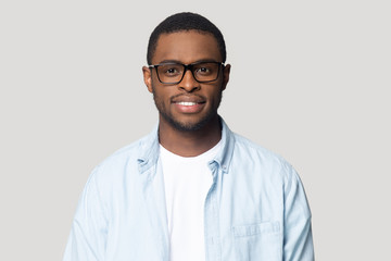 Headshot of african American male in glasses posing in studio
