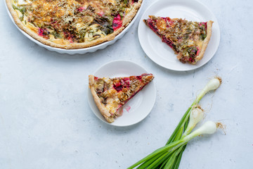 Vegetarian quiche with betroot greens and cheese. Overhead view. Seasonal snack