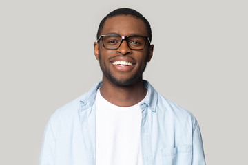 Portrait of smiling black man in glasses isolated in studio