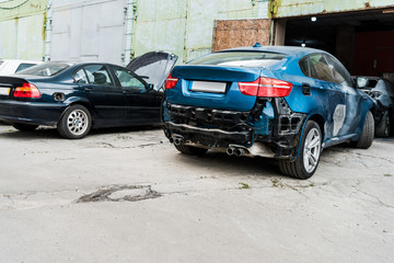 damaged blue car after car accident near modern automobile