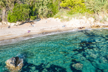 Aerial view of beautiful seashore in summer. Rocky beach and green islands seen from above.