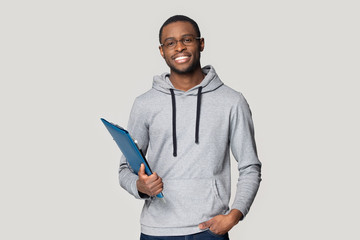 Smiling black male student stand holding binder case