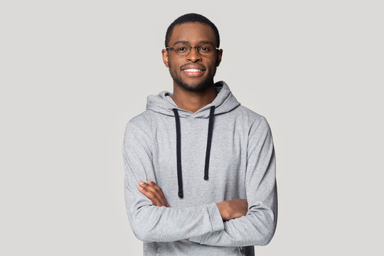 Smiling black male in glasses stand with arms crossed