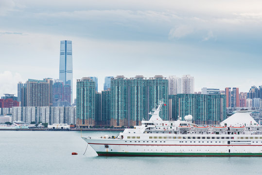 Cruise Ship In Harbor And Skyline Of Hong Kong City