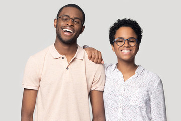 Smiling ethnic couple in glasses laugh posing for picture