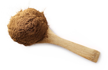 Cinnamon powder with wooden spoon isolated on white background, top view