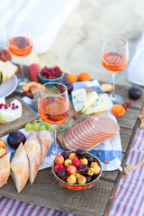 Picnic on the beach at sunset in the style of boho, food and drink conception - 279790391