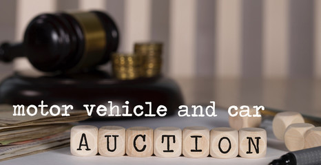 Words MOTOR VEHICLE AND CAR AUCTION composed of wooden dices.