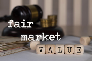 Words FAIR MARKET VALUE composed of wooden dices.