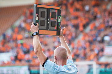 Technical referee shows 3 minutes added time during the football match.