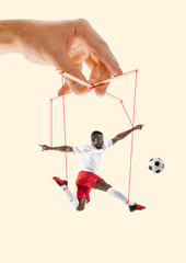 Man like a puppet in somebodies hands on yellow background. Concept of unfair manipulation,...