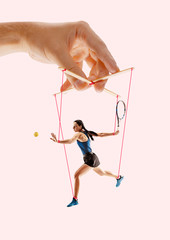 Woman like a puppet in somebodies hands on coral background. Concept of unfair manipulation,...