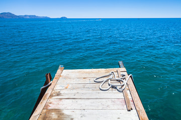 Small wooden pier with mooring ropes