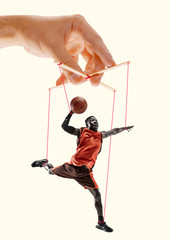 Man like a puppet in somebodies hands on yellowbackground. Concept of unfair manipulation,...