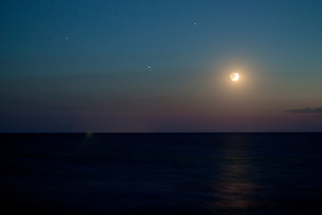 Fototapeta na wymiar The sunset and the moon and the sea