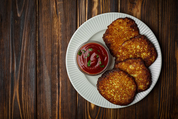 potato pancakes, hash brown in a plate on a wood background