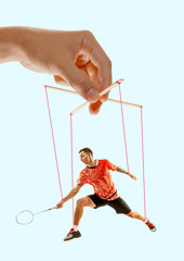 Boy like a puppet in somebodies hands on blue background. Concept of unfair manipulation, phycology...