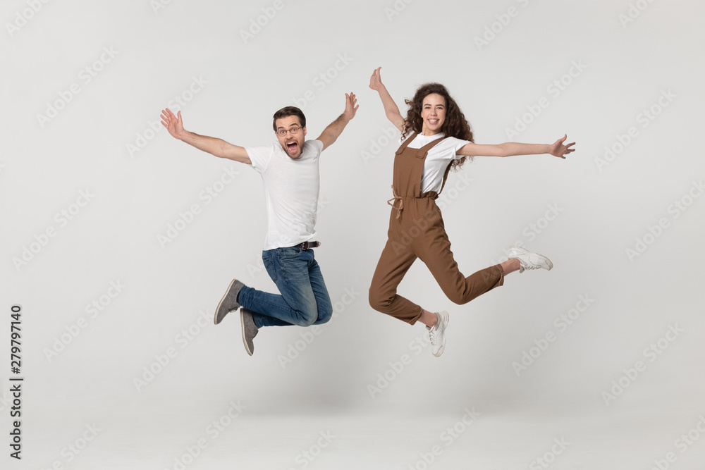 Wall mural couple was photographed in a jump isolated on grey background