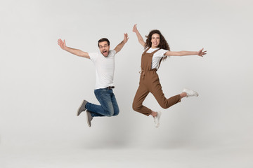 Couple was photographed in a jump isolated on grey background