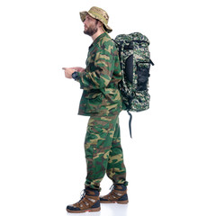 Man in camouflage clothes with backpack hiking standing looking on white background isolation