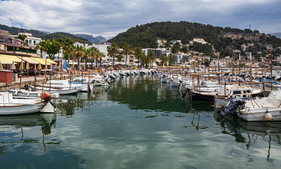 Fototapeta na wymiar The seafront and harbour at Port de Soller with yachts and boats, Spain