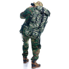 Man in camouflage clothes with backpack and photo camera hiking on white background isolation, back view