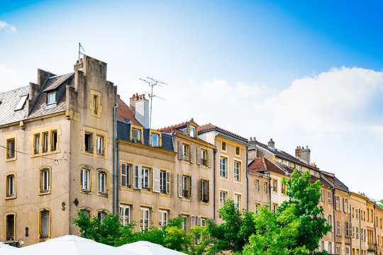 yellow apartments with white shutters on square Place Saint Louis. Metz, France