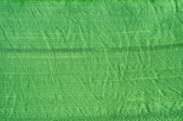 Fototapeta na wymiar Texture of green turquoise shantung silk fabric closeup as textile background