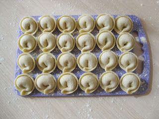 Siberian meat dumplings on a blue board. Top view. Close-up.