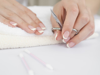 Obraz na płótnie Canvas Manicured hands holding nail scissors