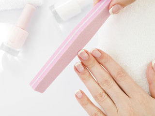 Top view woman hands using manicure tools