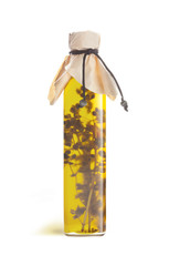 Olive oil in a bottle with fragrant herbs