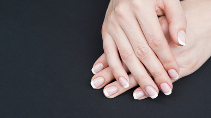 Close up woman hands on black background