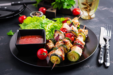 Grilled meat skewers, chicken  shish kebab with zucchini, tomatoes and red onions. Barbecue food.