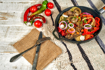 Chicken fried liver with vegetables at home in a frying pan