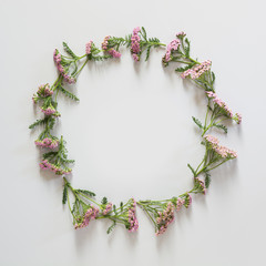 Flowers pattern of purple and pink flowers on grey background. Flat lay, top view. Space for text.