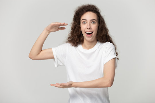 Amazed Woman Looking At Camera Showing With Hands Large Size