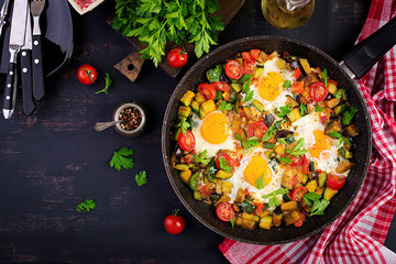 Late breakfast - fried eggs with vegetables. Shakshuka. Arabic cuisine. Kosher food. Top view