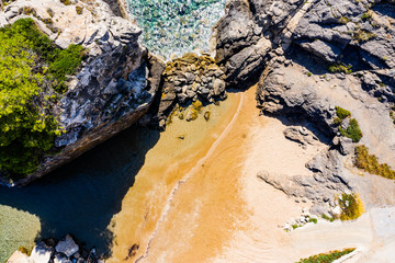 Aerial view of the ocean and beautiful rocks and islands. Summer background of beach, stones seen from above.